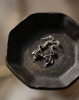 Garnet Whiplash Earrings on black ceramic dish