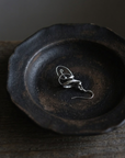 Twisted Ribbon Earring on black ceramic dish