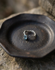 Blue Topaz Twig Ring on black ceramic dish