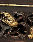 Detail of pierced gilt-highlighted peach, pomegranate and bird carving on the console drawer front