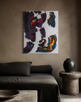 This Time 1 hung above a dark linen daybed in a warm plaster room