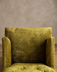 Chartreuse velvet diamond-tufted armchair, second high top-down angle of arm meeting seat cushion and waterfall front edge