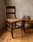 Antique cane seat chair staged in a reading nook