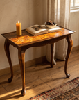 Burl walnut side table by a window with soft daylight