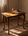 Vintage burl walnut side table styled in a warm room with candle and figs
