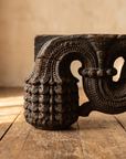 Detail of the carved end block and foot of the antique table