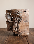 Carved teak temple capital, profile view of a parrot bracket and beaded garland