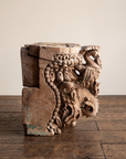 Carved teak temple capital, opposite profile showing a parrot bracket and foliage