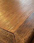 Macro detail of the honey bamboo-strip top and worn elm border
