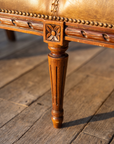 Detail of the carved rosette leg block and fluted Louis XVI tapered leg