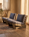 Pair of low armless lounge chairs, angled three-quarter view