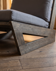Detail of the weathered solid-wood angular base and joinery