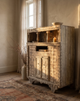 Antique hand-carved Indian cabinet, front view in a warm plaster room