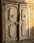 Detail of the carved lower double doors with iron ring pulls