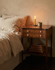 Antique mahogany side table styled as a candlelit bedside table