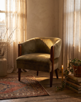 Olive velvet Art Deco club tub chair in a warm wabi-sabi room