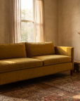 Mustard velvet sofa, three-quarter view from the left