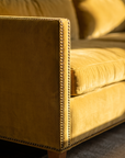 Detail of the brass nailhead trim on the track arm