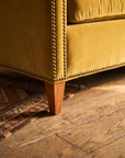 Detail of the tapered wood leg on an antique rug