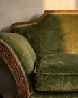 Detail of green velvet pile and carved wooden arm
