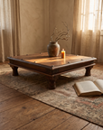Antique iron-studded Indian bajot table in a warm plaster OE room