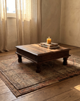 Antique worn walnut Indian bajot table in a warm plaster OE room