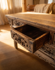 One drawer of the antique altar table pulled open showing the aged solid-wood box