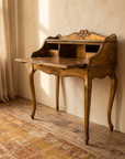 Three-quarter view of the open Florentine desk showing cabriole legs and interior cubbies