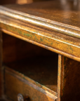 Macro detail of the aged gold finish with green patina showing through