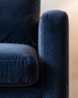Macro detail of the navy velvet texture and welted seam