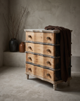 The Curvy Dresser, serpentine four-drawer chest, three-quarter view in a greige plaster room