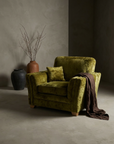 Olive velvet channel-arm club chair, three-quarter view