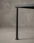 Macro detail of one leg and round foot on the Floral Scroll grate table