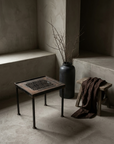 Antique Grate Side Table, Geometric Lattice design, styled in a greige plaster room with a stoneware vessel and dried branches