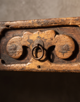 Macro detail of the carved cloud-bracket drawer pull, alternate angle