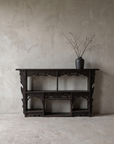 Antique carved black wall shelf, straight-on front view at true scale showing full construction and cubby grid