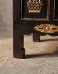 Detail of the console's corner block foot and pierced gilt floral apron medallion