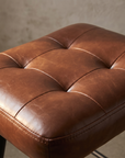 Alternate macro detail of the diamond tufted cognac pleather seat