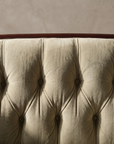Macro detail of the center back diamond button-tufting and dark wood crest rail
