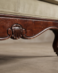 Macro detail of the carved shell apron medallion, cabriole leg, and castor