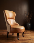 Cognac leather wingback slipper chair, three-quarter view showing full silhouette