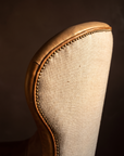 Detail of brass nailhead trim along the curve of the chair back