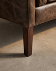 Second macro detail of the tapered wood leg and base construction
