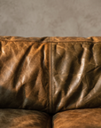 Macro detail of the cognac leather grain and center seam