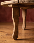 Antique round coffee table, lighter, leg detail alternate framing