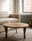 Antique round coffee table, lighter, lifestyle hero in a small NYC apartment