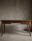 The Cabriole Writing Desk, vintage French Provincial writing desk in a greige plaster room with stoneware vessels and dried branches