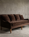 Chocolate velvet tufted sofa, three-quarter view