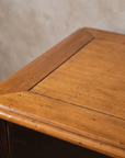 Detail of the natural wood top with dark inlay banding