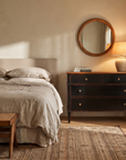 Atelier de Madeleine chest in a fully furnished bedroom with bed, mirror, and lamp, correctly scaled at full size, Axel Vervoordt wabi-sabi style